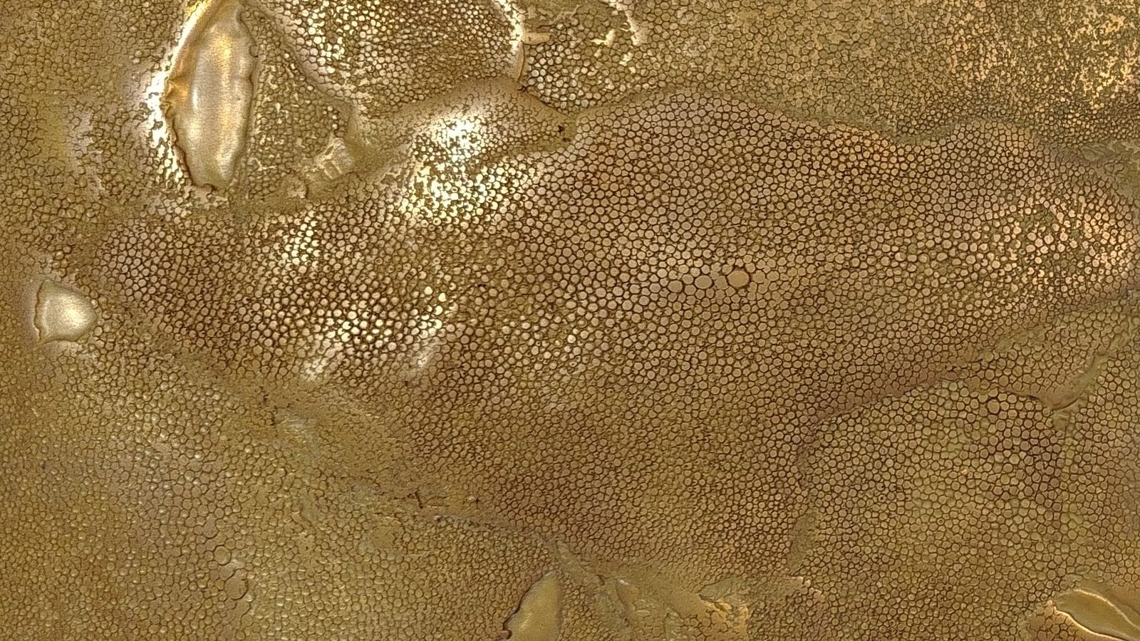 Close-up of Talos Luxury Panels' Rugged Shagreen finish in Gold Brass, a hand-poured textured metallic wall panel
